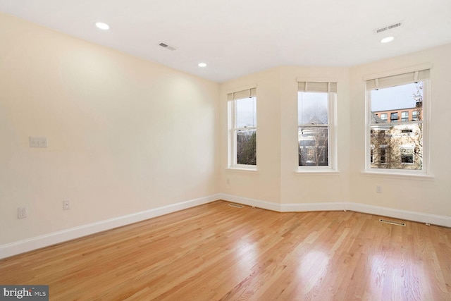 spare room with light hardwood / wood-style flooring