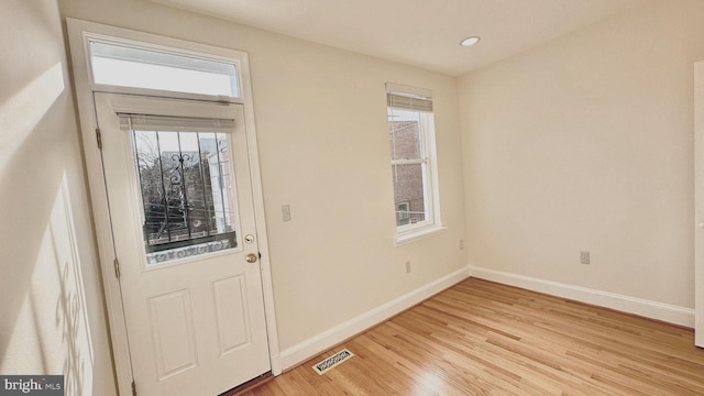 foyer entrance with light hardwood / wood-style flooring