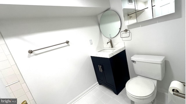 bathroom featuring toilet, tile patterned floors, and vanity