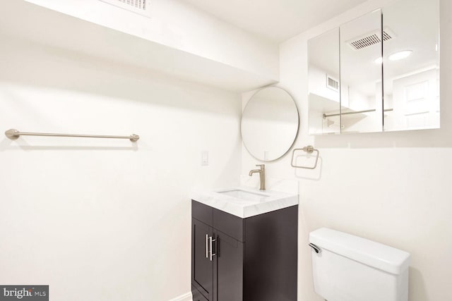 bathroom featuring toilet and vanity