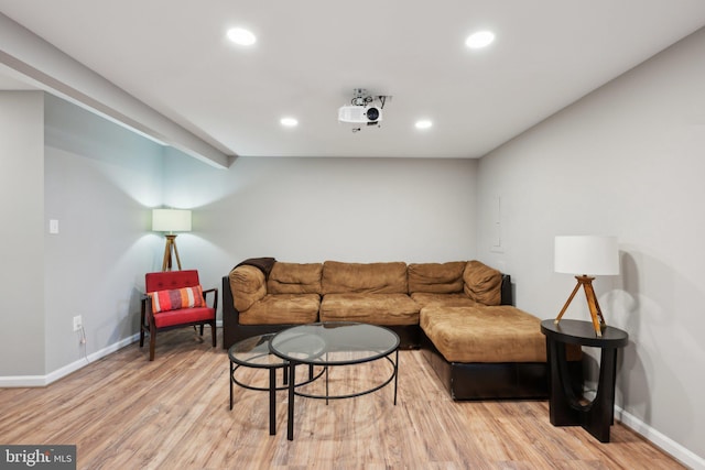 living room with recessed lighting, light wood-type flooring, and baseboards