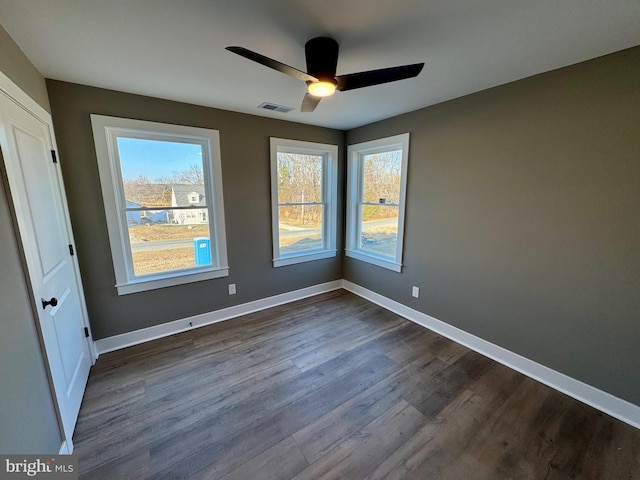 spare room with plenty of natural light, baseboards, and visible vents