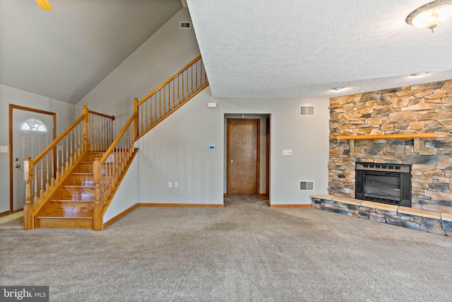 unfurnished living room with visible vents, a fireplace, baseboards, and stairs