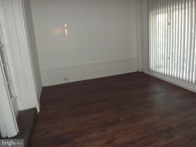 spare room with dark hardwood / wood-style floors