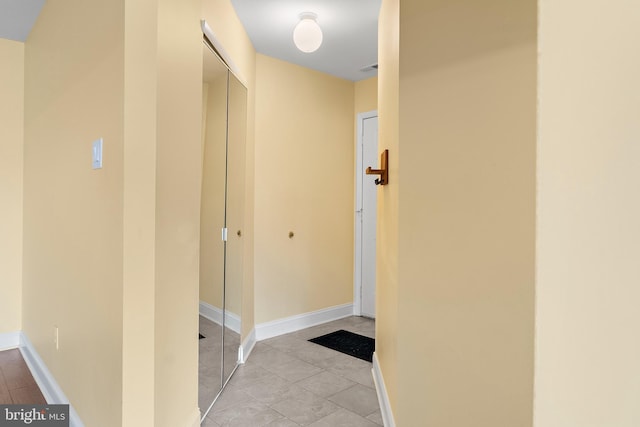 corridor featuring light tile patterned floors