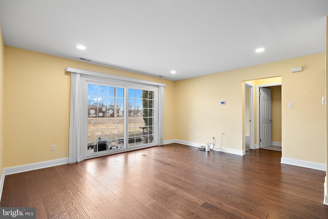 spare room with dark hardwood / wood-style flooring