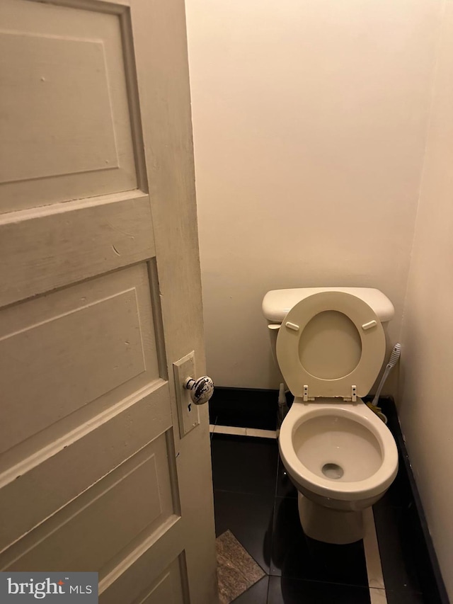 bathroom with tile patterned flooring and toilet