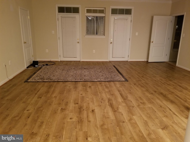 entrance foyer featuring light wood-style floors and baseboards