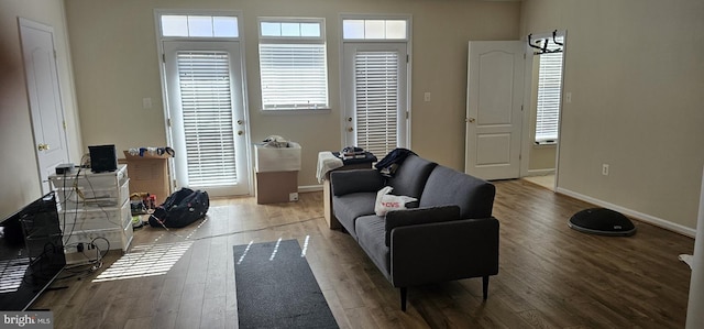 living area featuring baseboards and wood finished floors