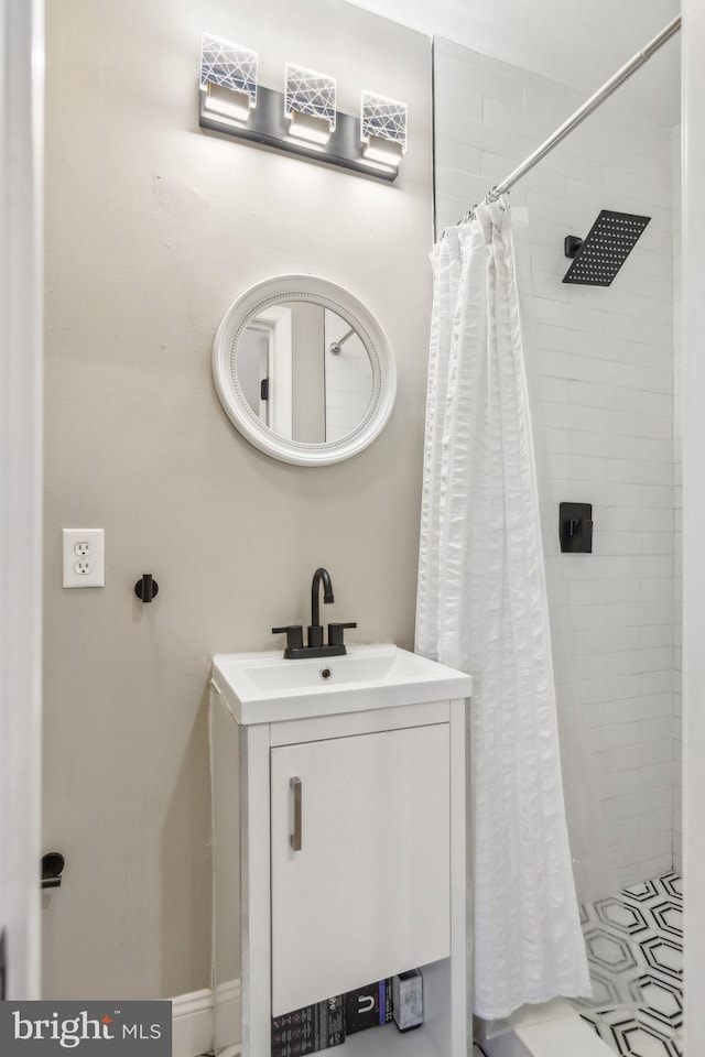 full bathroom featuring a shower stall and a sink