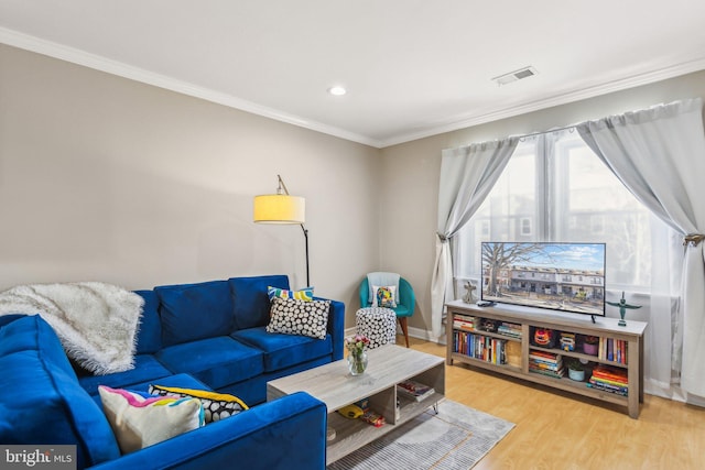 living room featuring visible vents, crown molding, baseboards, and wood finished floors