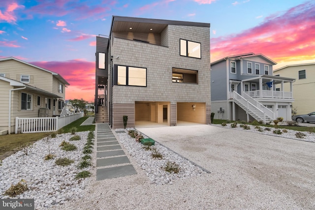 contemporary house featuring driveway and stairs