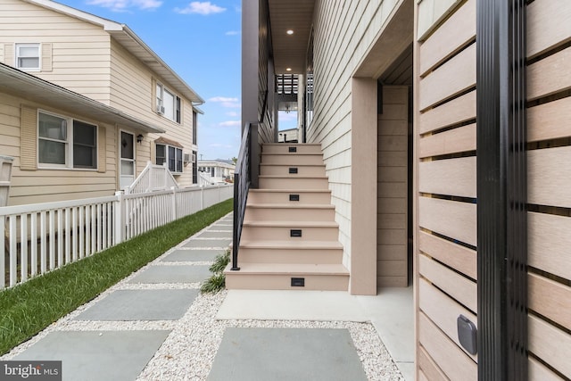 doorway to property featuring fence