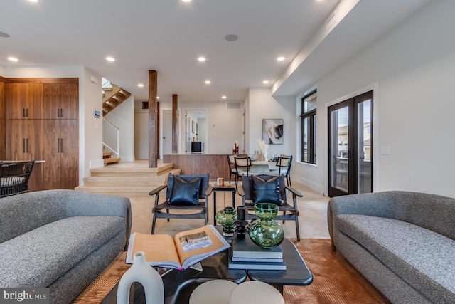 living area with stairs, baseboards, light wood-style flooring, and recessed lighting