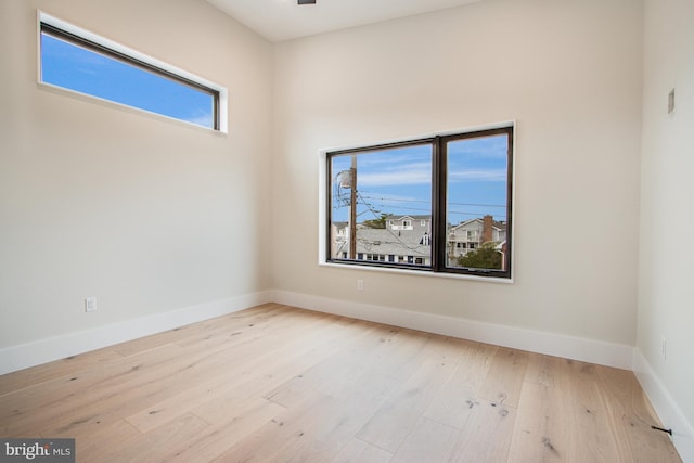 empty room with wood finished floors and baseboards