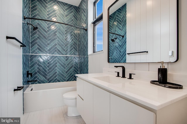 full bath featuring tub / shower combination, vanity, and toilet