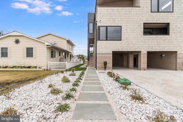 view of home's exterior with a carport and gravel driveway