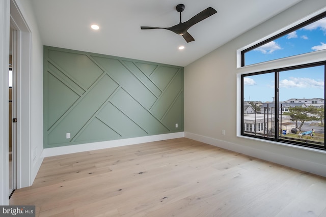 spare room featuring baseboards, recessed lighting, light wood-style flooring, and a ceiling fan