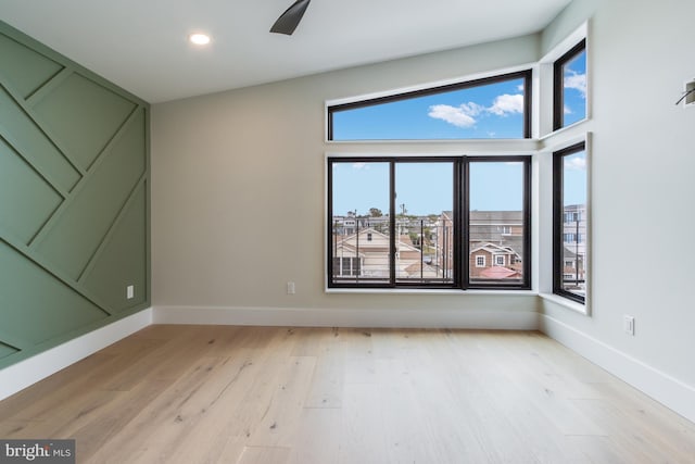 unfurnished room featuring recessed lighting, light wood-style flooring, and baseboards