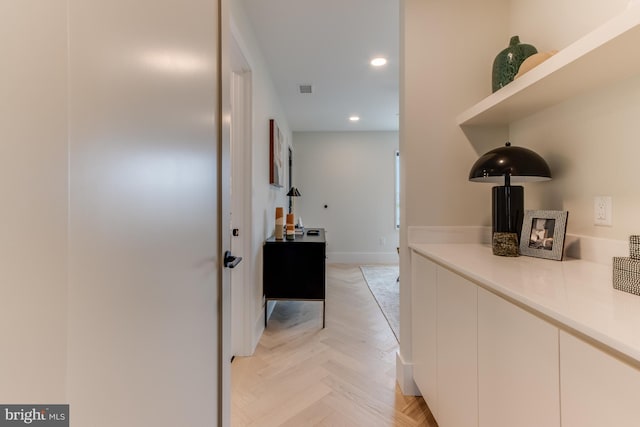 corridor featuring recessed lighting, visible vents, and baseboards