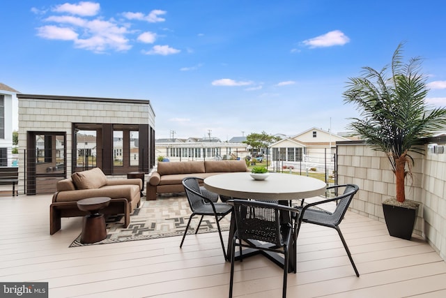 wooden deck with outdoor dining area and an outdoor living space