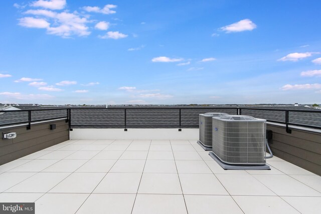 view of patio with a balcony and central air condition unit