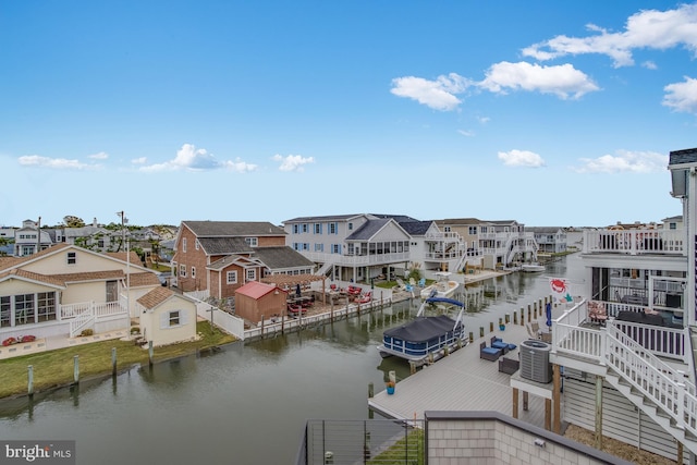 drone / aerial view featuring a water view and a residential view