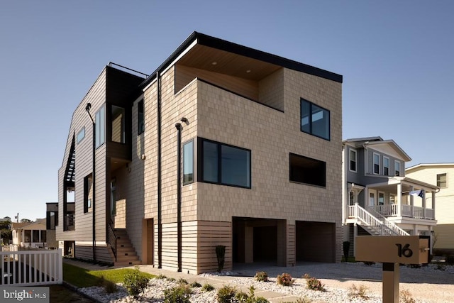 view of building exterior with stairs and a garage