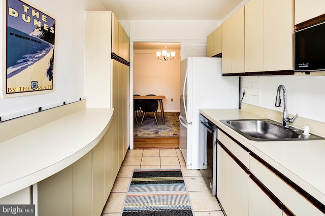 kitchen featuring hanging light fixtures, black appliances, light countertops, and a notable chandelier