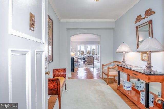 hallway with ornamental molding, arched walkways, and parquet floors