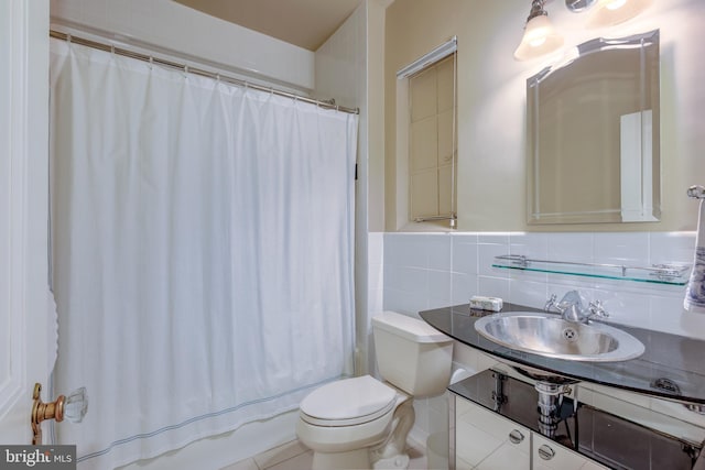 full bathroom with toilet, curtained shower, tile walls, and vanity