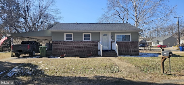 bungalow-style house with a carport, brick siding, a front lawn, and driveway