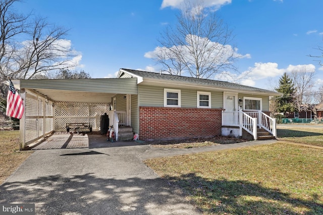 view of front facade with a carport, driveway, brick siding, and a front yard