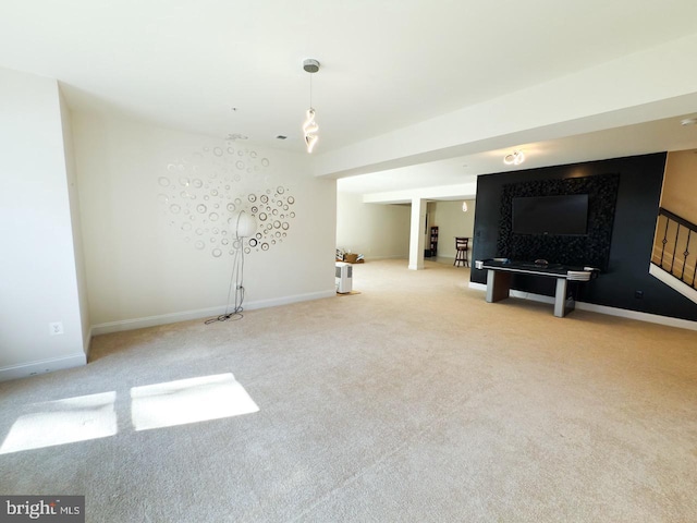 unfurnished living room with stairs, carpet flooring, and baseboards