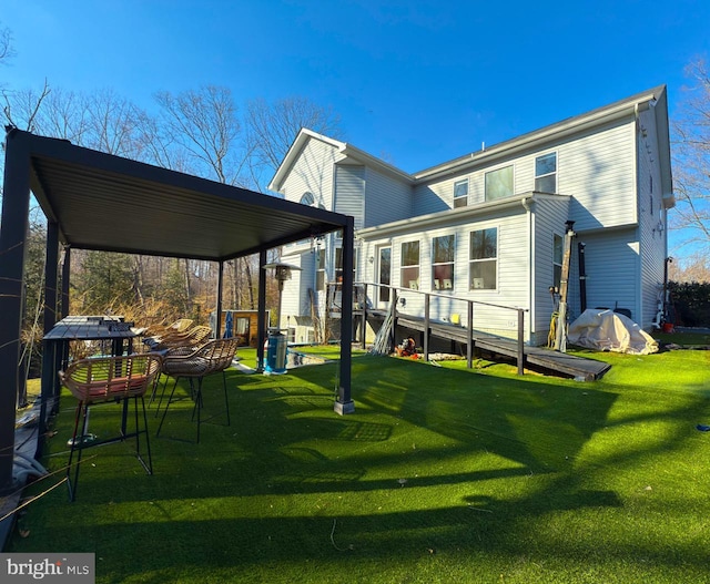 rear view of house featuring a lawn