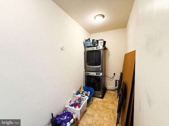 washroom featuring laundry area and stacked washer / dryer