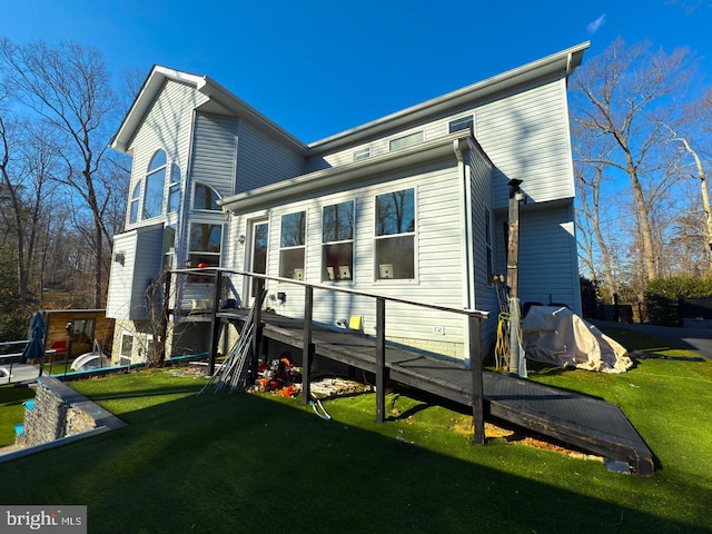 back of house with a lawn