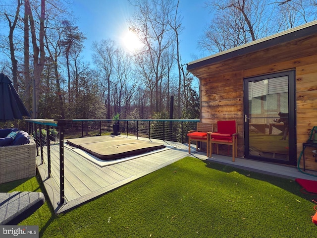 view of yard with a deck and a covered hot tub