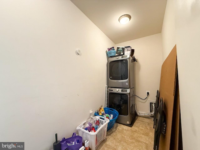 laundry room with stacked washer / drying machine and laundry area