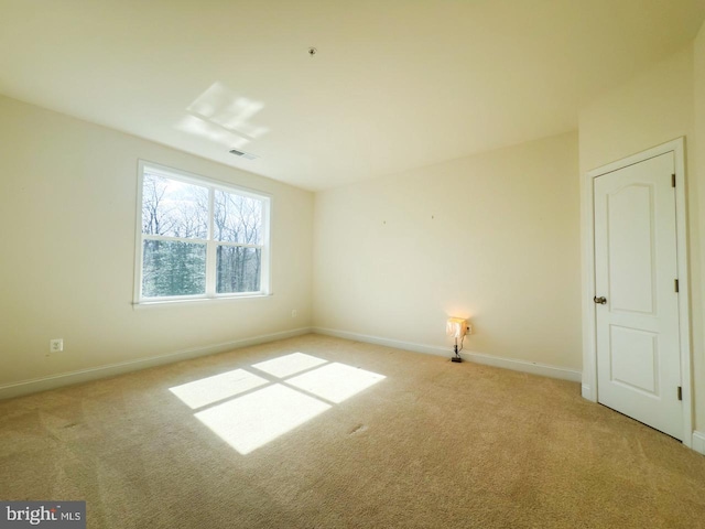 unfurnished room featuring visible vents, baseboards, and carpet flooring