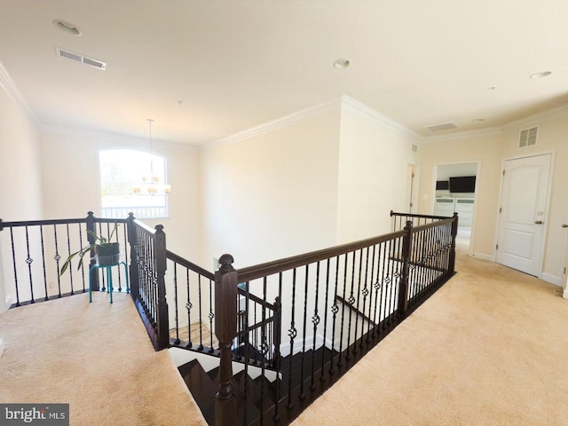 corridor featuring visible vents, an upstairs landing, carpet, and ornamental molding