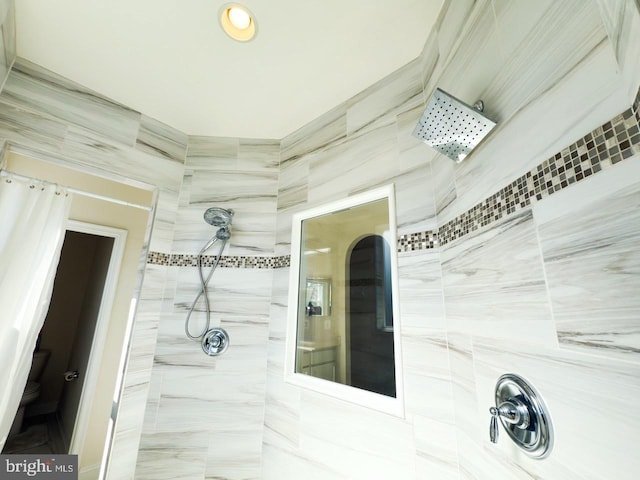 full bathroom with toilet and tiled shower