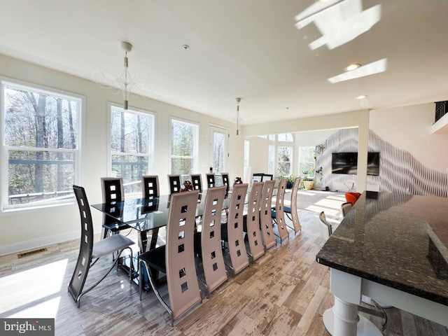 dining area with light wood finished floors, visible vents, recessed lighting, and baseboards