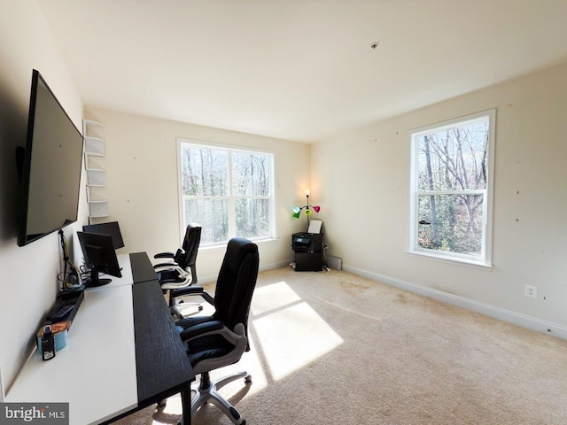 carpeted office featuring baseboards