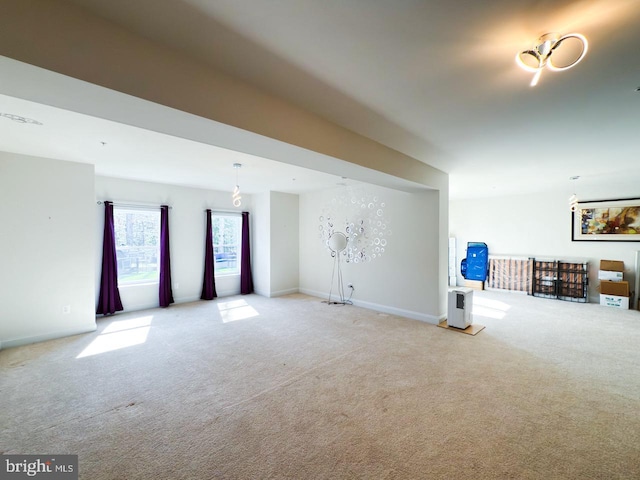 interior space with baseboards and carpet floors