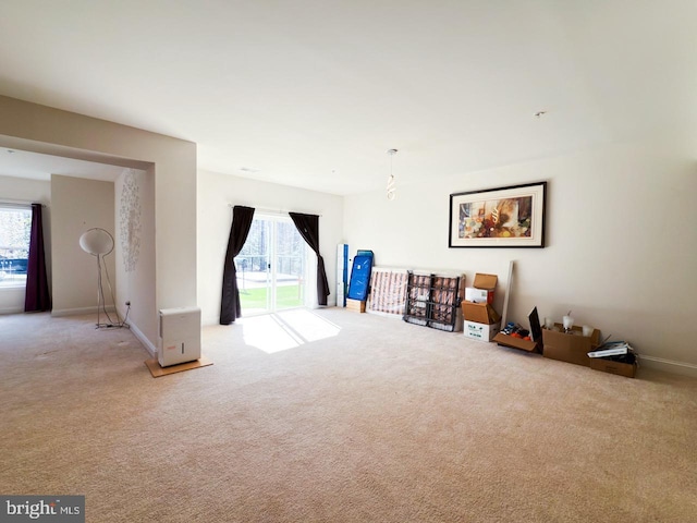 living area with carpet flooring and baseboards