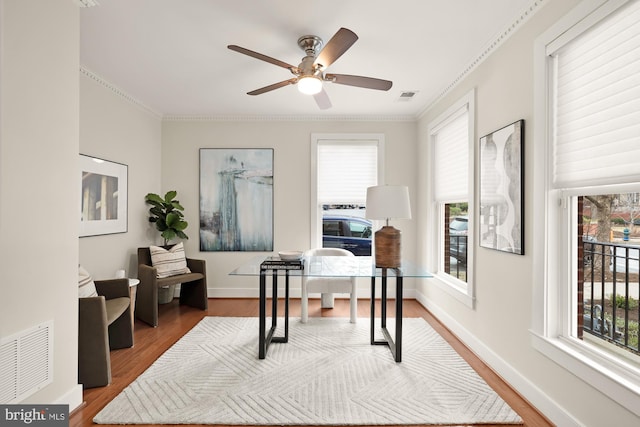 home office with a wealth of natural light, wood finished floors, and visible vents