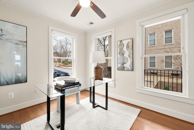 office featuring baseboards, visible vents, ceiling fan, and wood finished floors