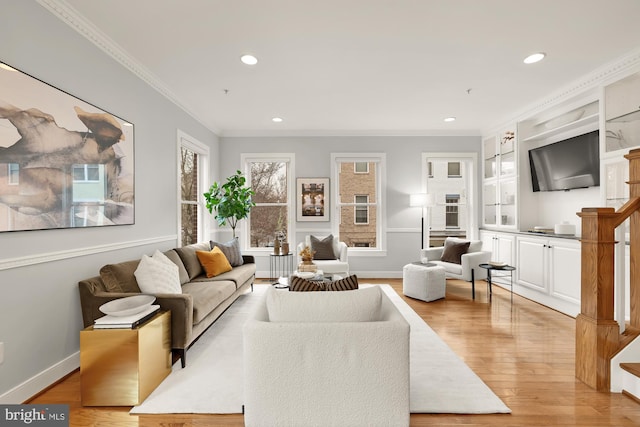 living area featuring baseboards, light wood finished floors, recessed lighting, and crown molding