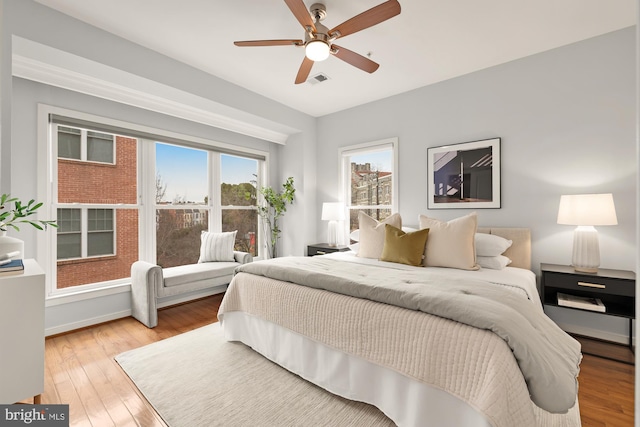 bedroom featuring visible vents, ceiling fan, and light wood finished floors